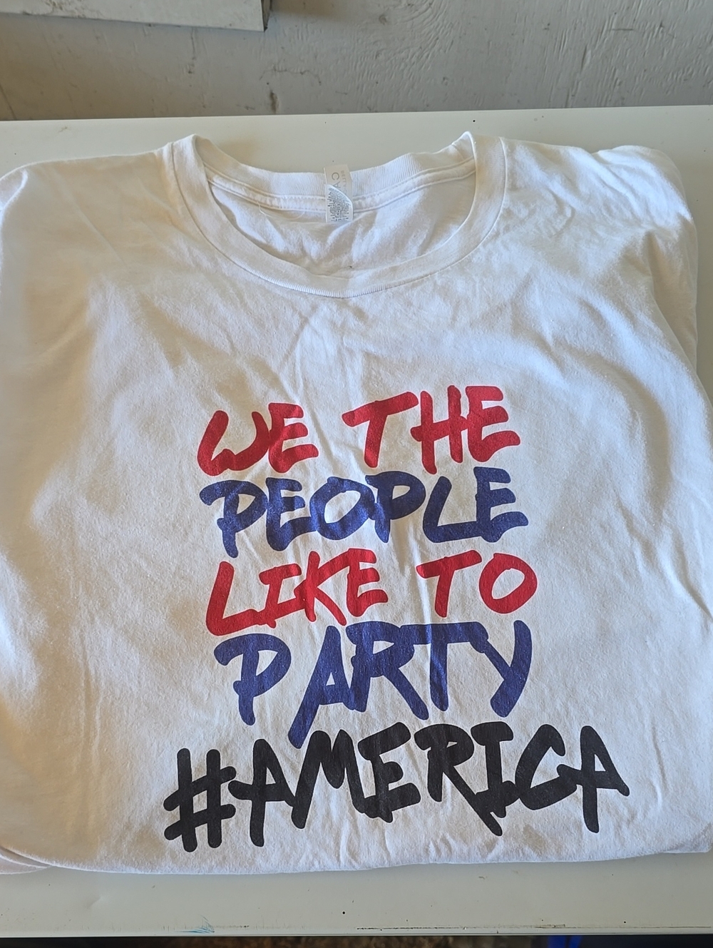 Source Unknown White Graphic Tee with Red, Blue and Black Text